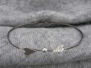 Soldered sterling silver details on blackened, polished iron wire (nickel free).