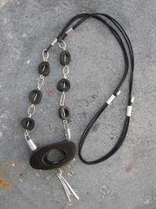 Sterling silver, coffee stained bone, leather cord.